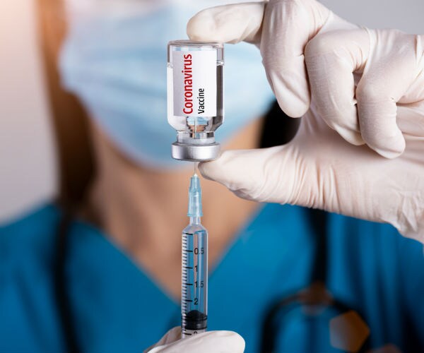 doctor with a syringe and coronavirus vaccine
