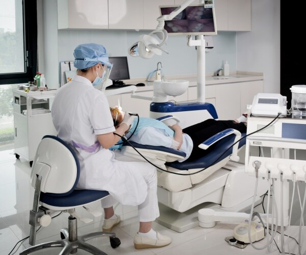 dentist looking at a patient's teeth and gums