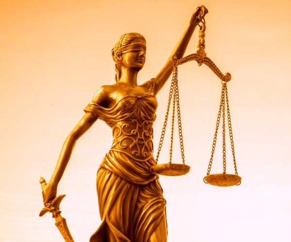 gold statue of justice with blindfold and scales