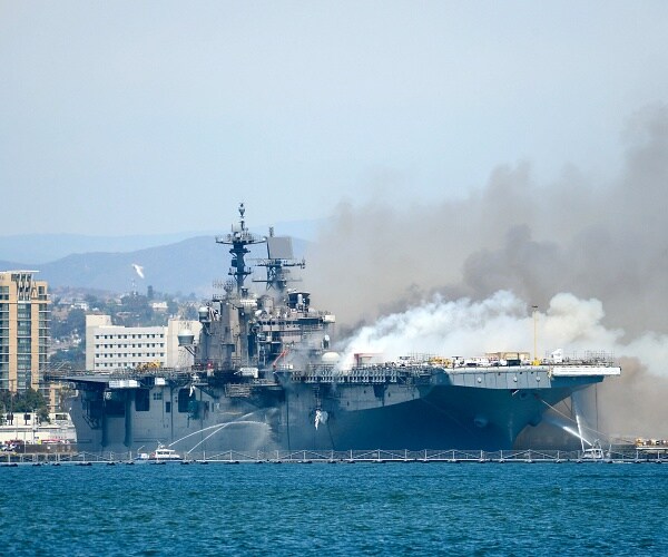 boats combat fire on navy ship