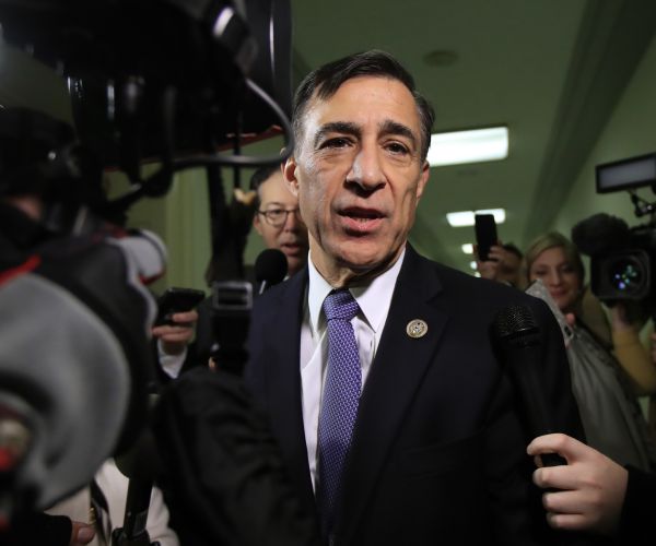 rep. darrell issa of california speaks to reporters as he walks to attend an interview. 