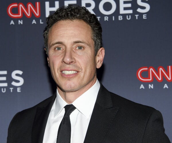 cnn's chris cuomo is shown in black suit, white dress shirt and black tie