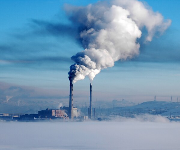 smoke pouring out of smokestacks