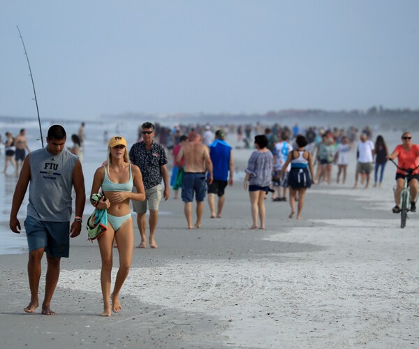 people walk on jacksonville beach in florida