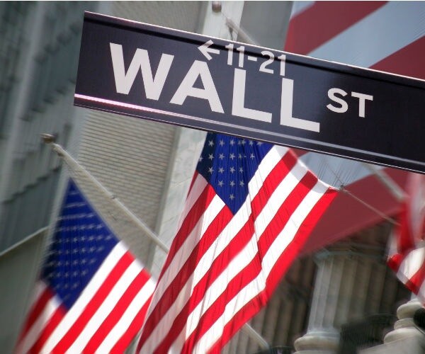 wall street street sign amid american us flags