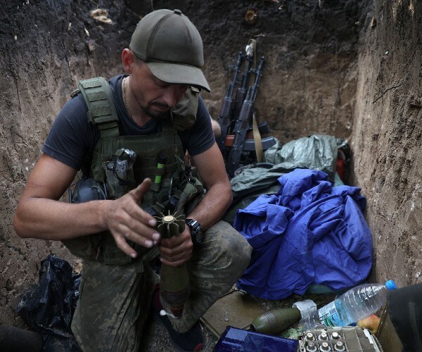 soldier prepares mortar shells 