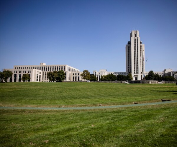the building is at the end of a large grass lawn