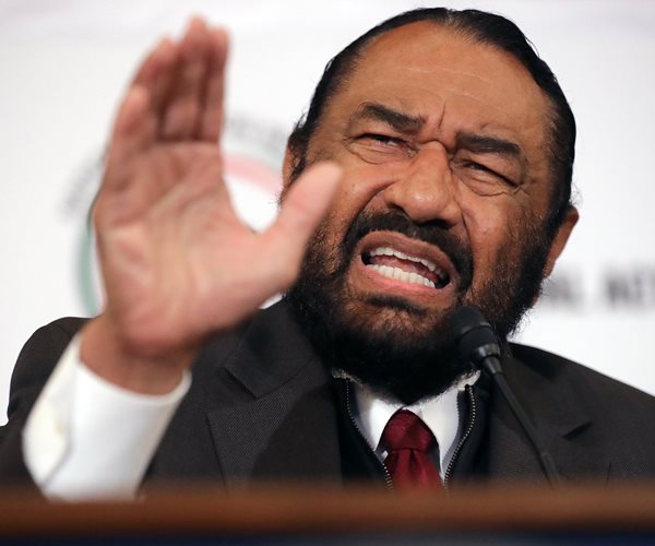 head-on photo of rep al green with right hand raised