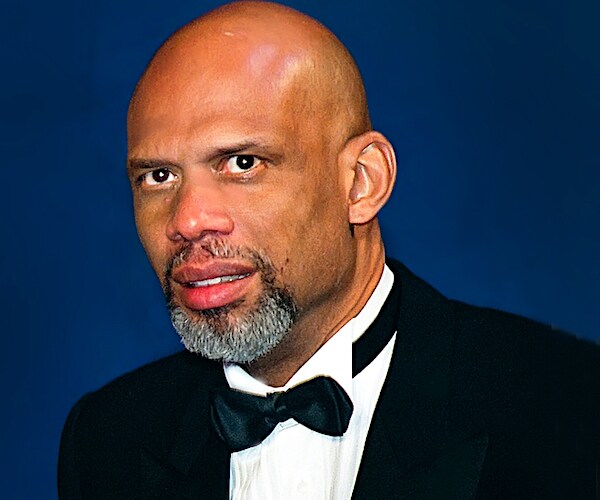 kareem abdul-jabbar poses for a photo in a tuxedo