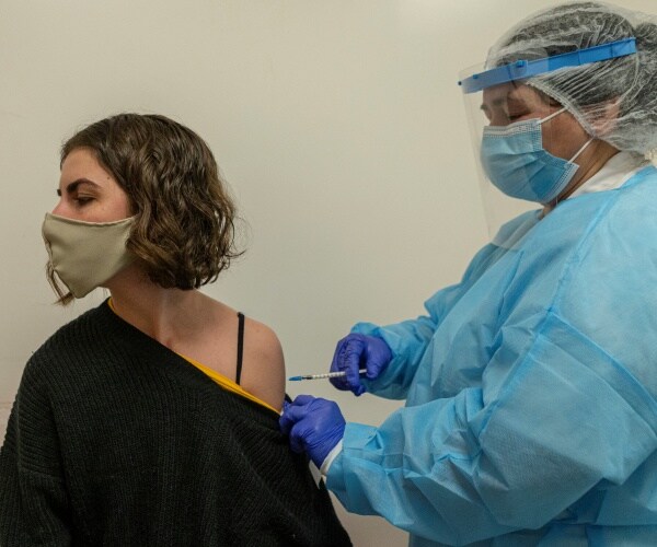 A woman receives her VOCID-19 vaccine.