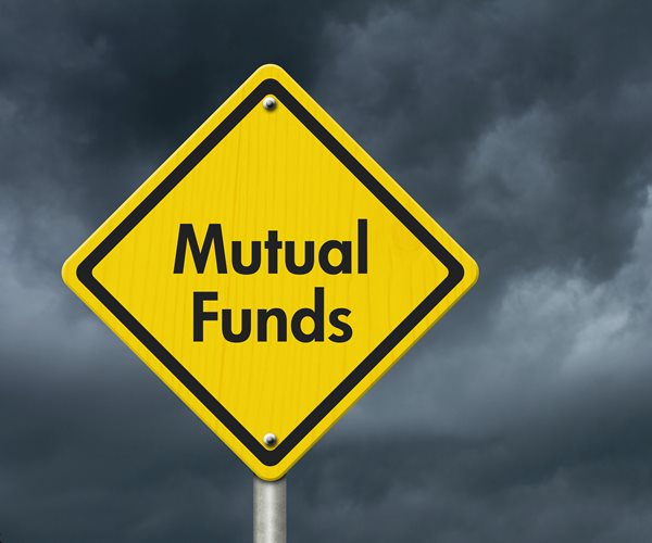 yellow diamond road sign saying mutual funds seen against cloudy sky background 