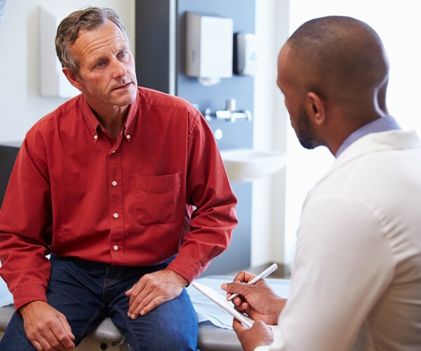A man meets with his doctor