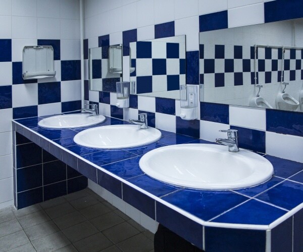 public bathroom with sinks with blue and white tiles