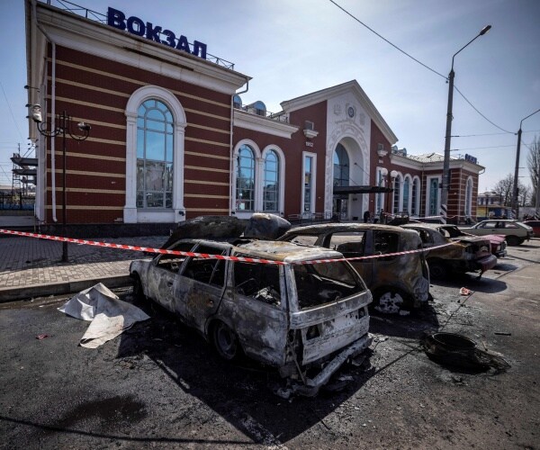 calcinated cars are pictured outside a train station
