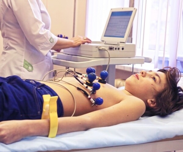 child laying in hospital bed