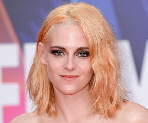 kristen stewart stands on red carpet