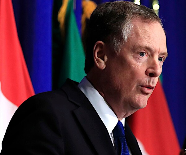Robert Lighthizer leans into the mic to speak during a news conference