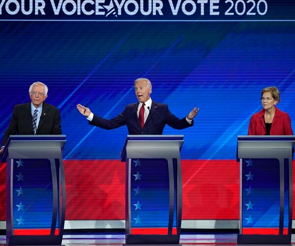 joe biden speaks while bernie sanders and elizabeth warren listen