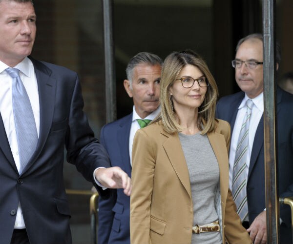 lori loughlin is shown in a brown jacket exiting a courthouse with her husband and attorney
