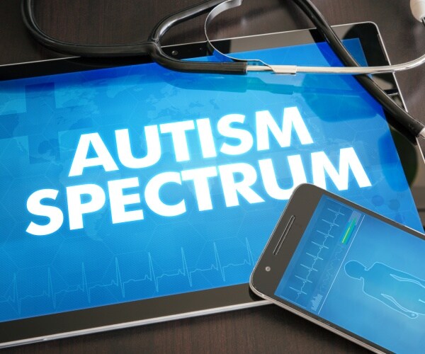 'autism spectrum disorder' on screen of tablet, stethoscope