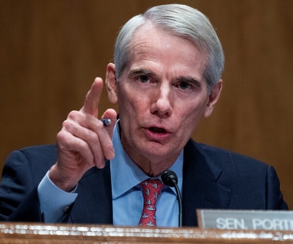 rob portman speaks into microphone