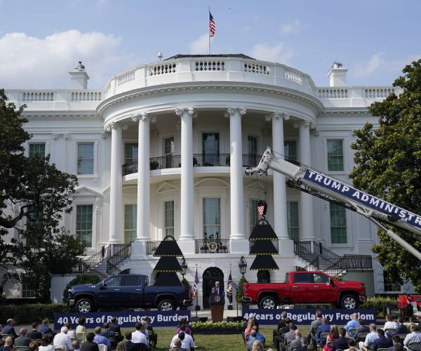 two pickup trucks with a crane reading trump administration at the event on the white house lawn
