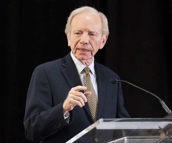 former Sen. Joe Lieberman is shown speaking at a podium