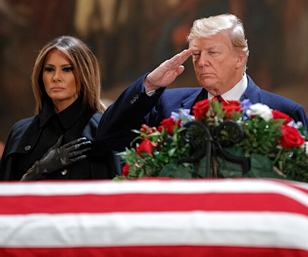 president donald trump salutes the casket of former president george h.w. bush alongside first lady melania trump