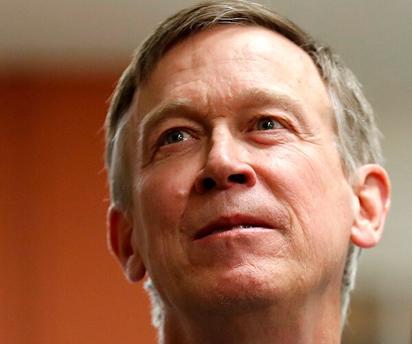 john hickenlooper sticks his chin out and looks up while listening to a reporter's question