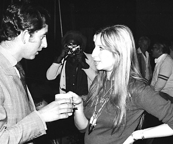 Actress and singer Barbra Streisand offers a cup of coffee to Prince Charles of Great Britain as they chat in 1974