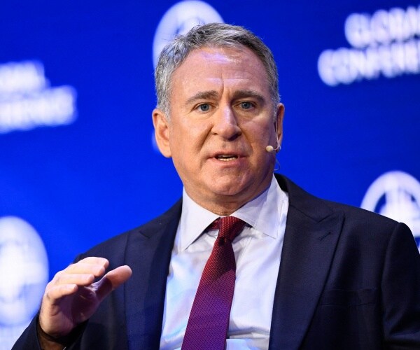 ken griffin speaks into a microphone