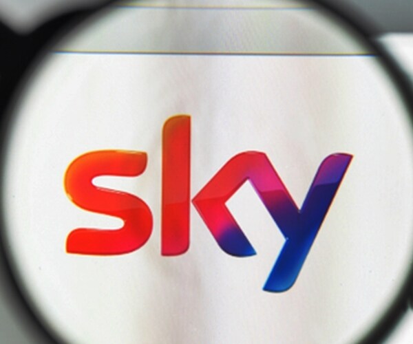 Sky website homepage with SKY rainbow logo viewed through a magnifying glass
