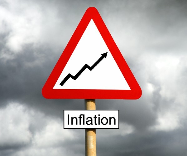 a road sign reading inflation with storm clouds in the background