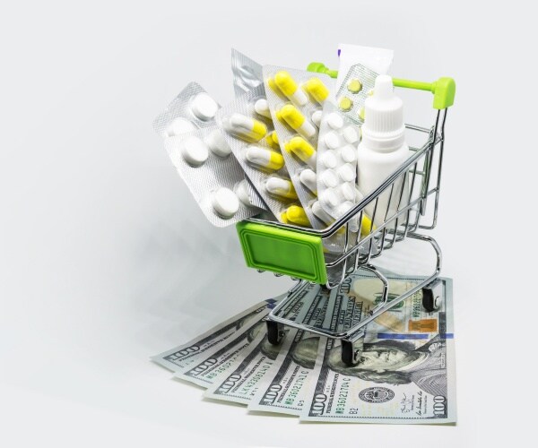 shopping cart with medications and $100 bills under it