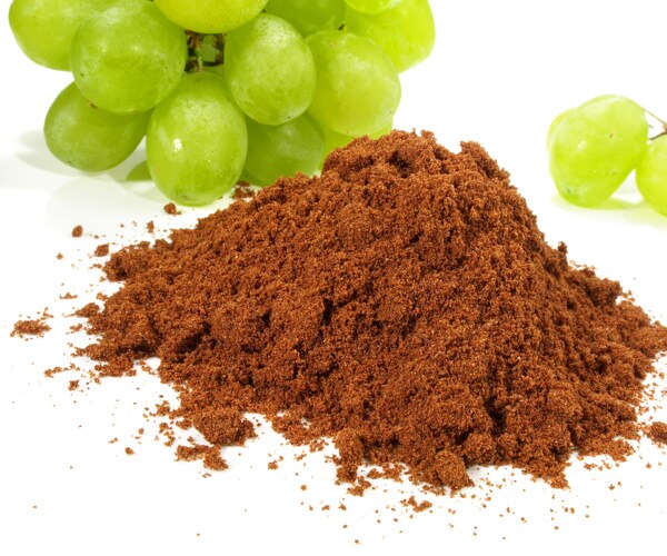 green grapes and a pile of brown grape powder