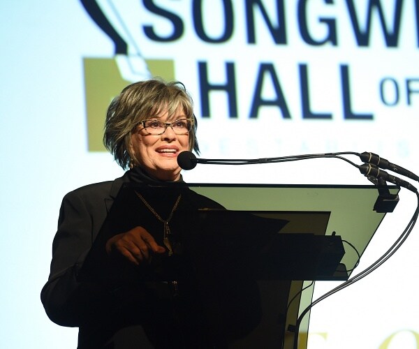 kt oslin speeaks into microphone