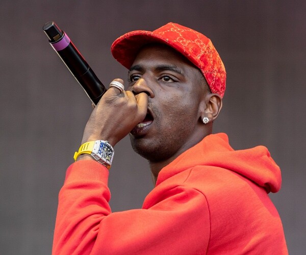 young dolph sings into mic onstage