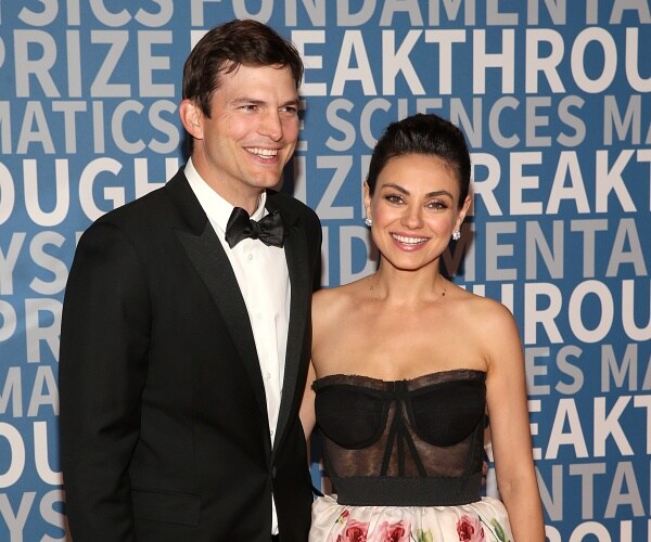ashton kutcher and mila kunis stand on red carpet