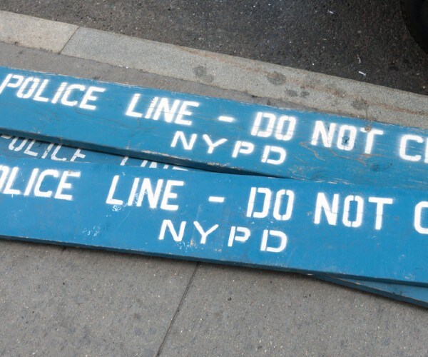 wooden slats reading police line do not cross n y p d