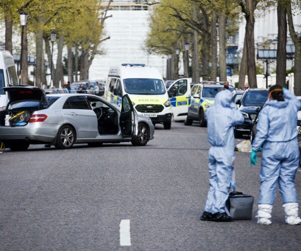 police investigate with the car in the background