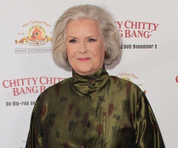 sally ann howes stands on red carpet