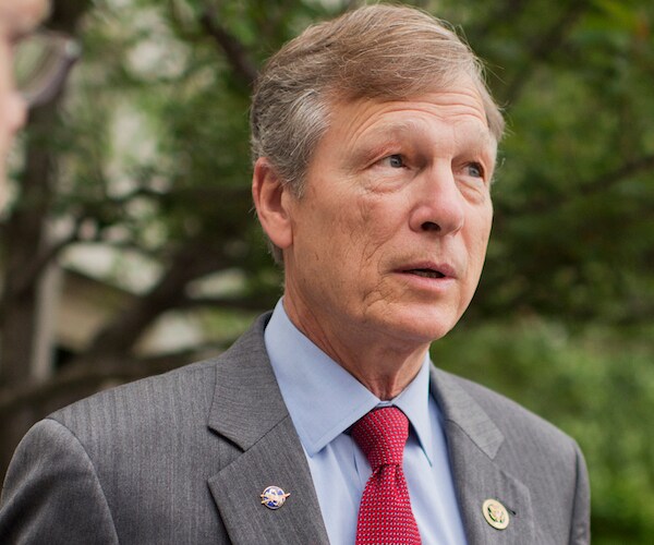 brian babin walks outdoors before a media news conference