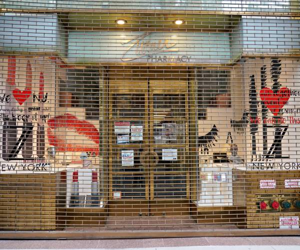 pharmacy with gates shuttered in front