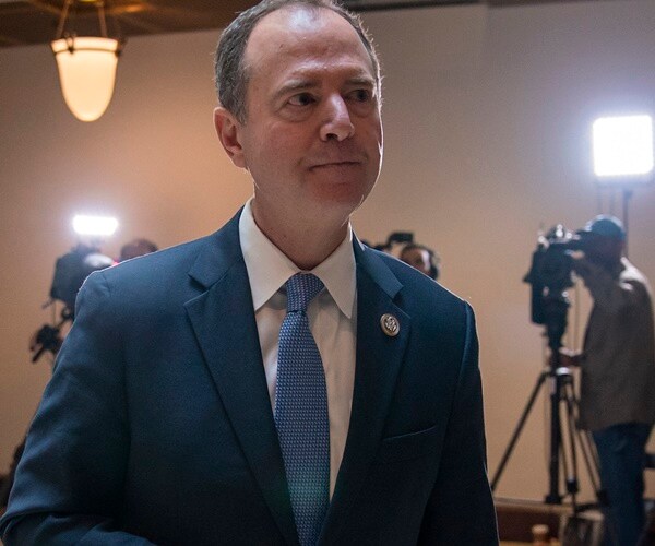 adam schiff walks through the capitol with cameras