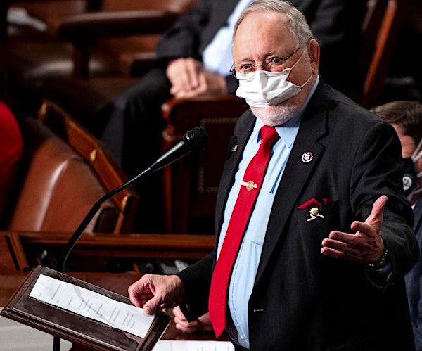 don young wears a face mask as he speaks on the floor of the house
