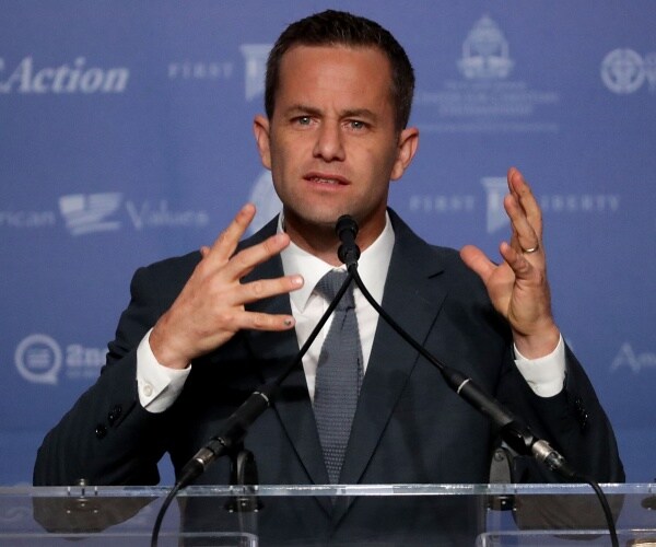 actor kirk cameron in a suit and gray tie speaking at a conference