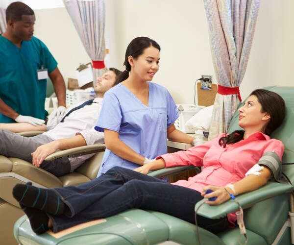 a man and a woman donating blood at a hospital