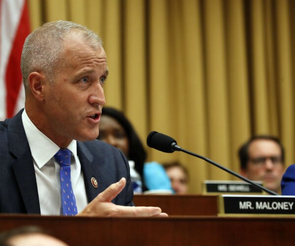 sean patrick maloney asking questions at a house intel committee hearing in blue suit, tie and  white dress shirt 