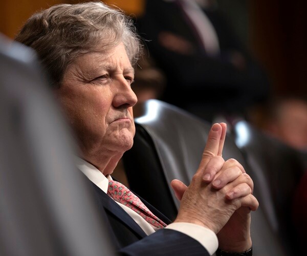 sen. john kennedy listens with his hands folded infront of him