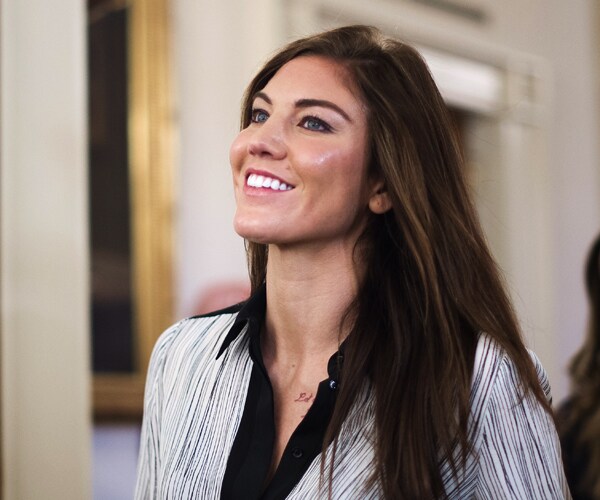 hope solo looks up and smiles wide